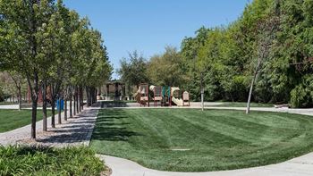 A park with some playground equipment and trees